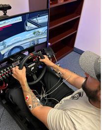 man sitting at driving simulator